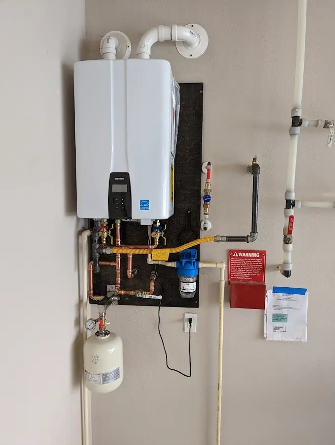Professional plumber installing copper piping in a Midway home